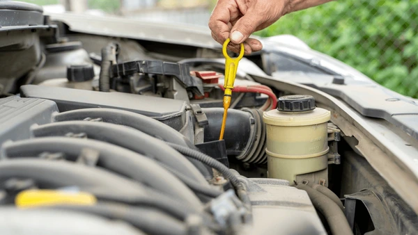 New driver checking car engine bay