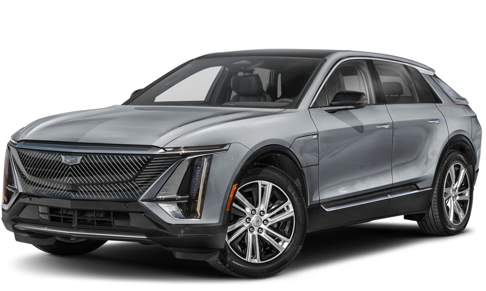 Front three-quarter view of a Cadillac Lyriq parked on a scenic road, showcasing its bold grille, sharp LED headlights, and sleek, futuristic SUV design.