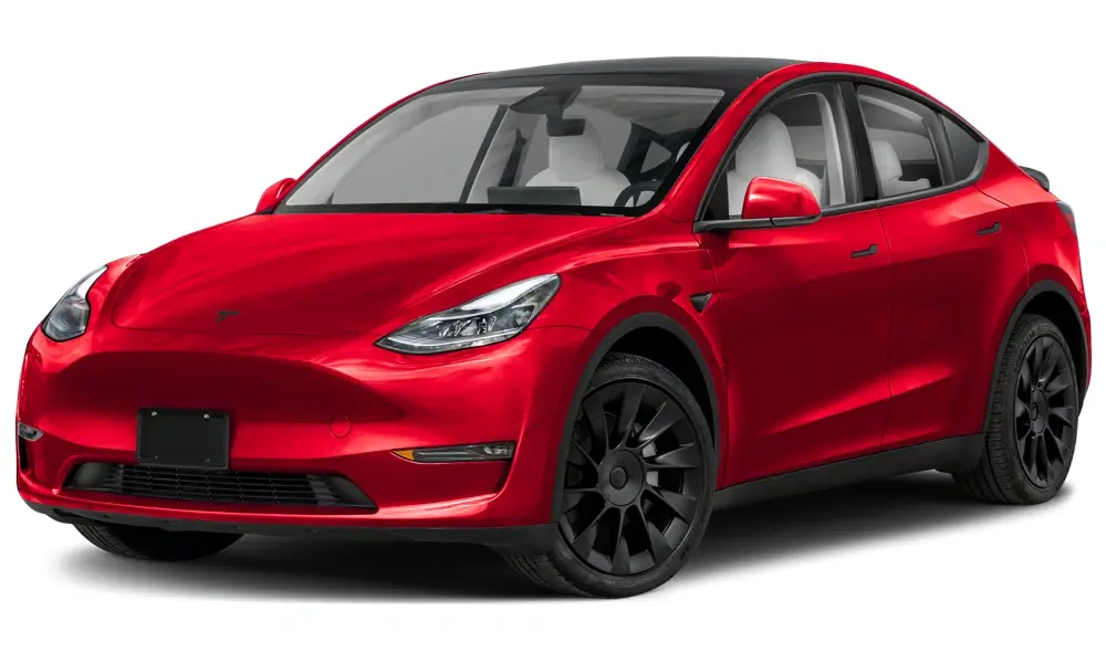Tesla Model Y in a minimalist driveway setting, showcasing its smooth curves, glass roof, and signature front end — a blend of performance and practicality.