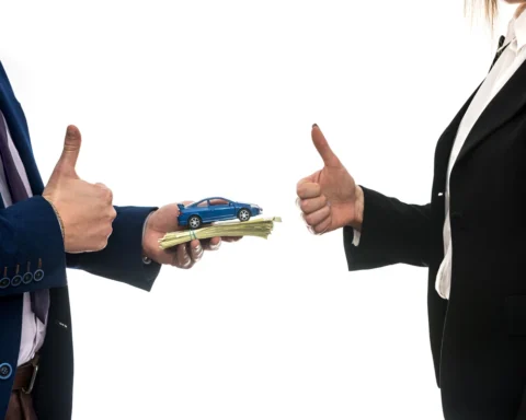 Two people exchange a stack of cash topped with a toy car; both give a thumbs-up, symbolizing a successful car deal and mutual satisfaction in a car purchase transaction
